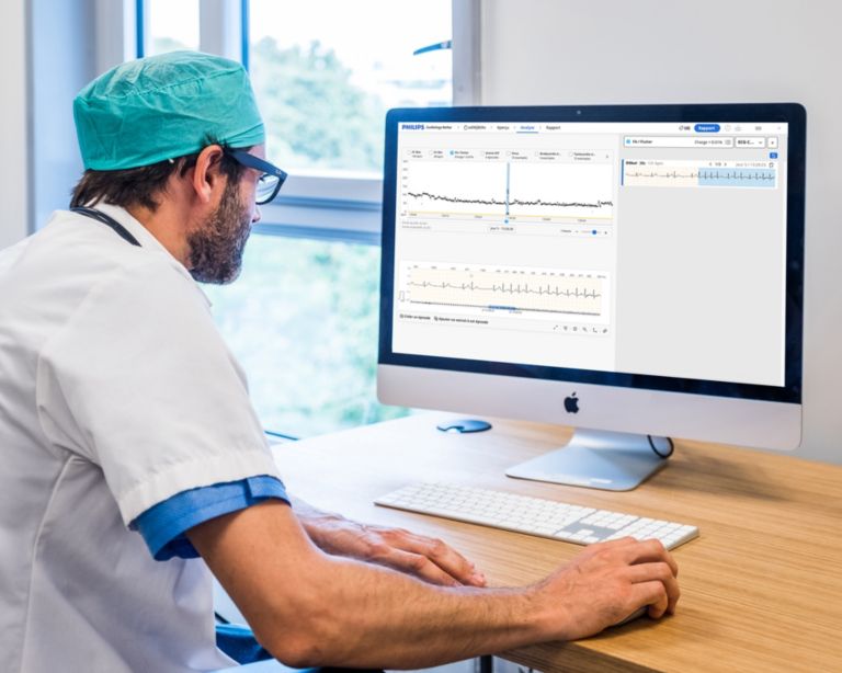 A clinician reviews Philips Cardiologs Holter data on his computer