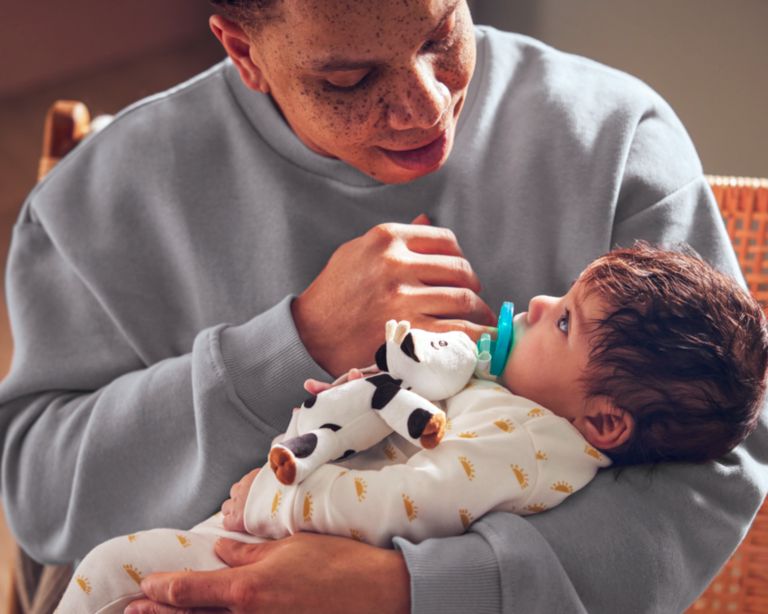 Image of an adult holding a baby.