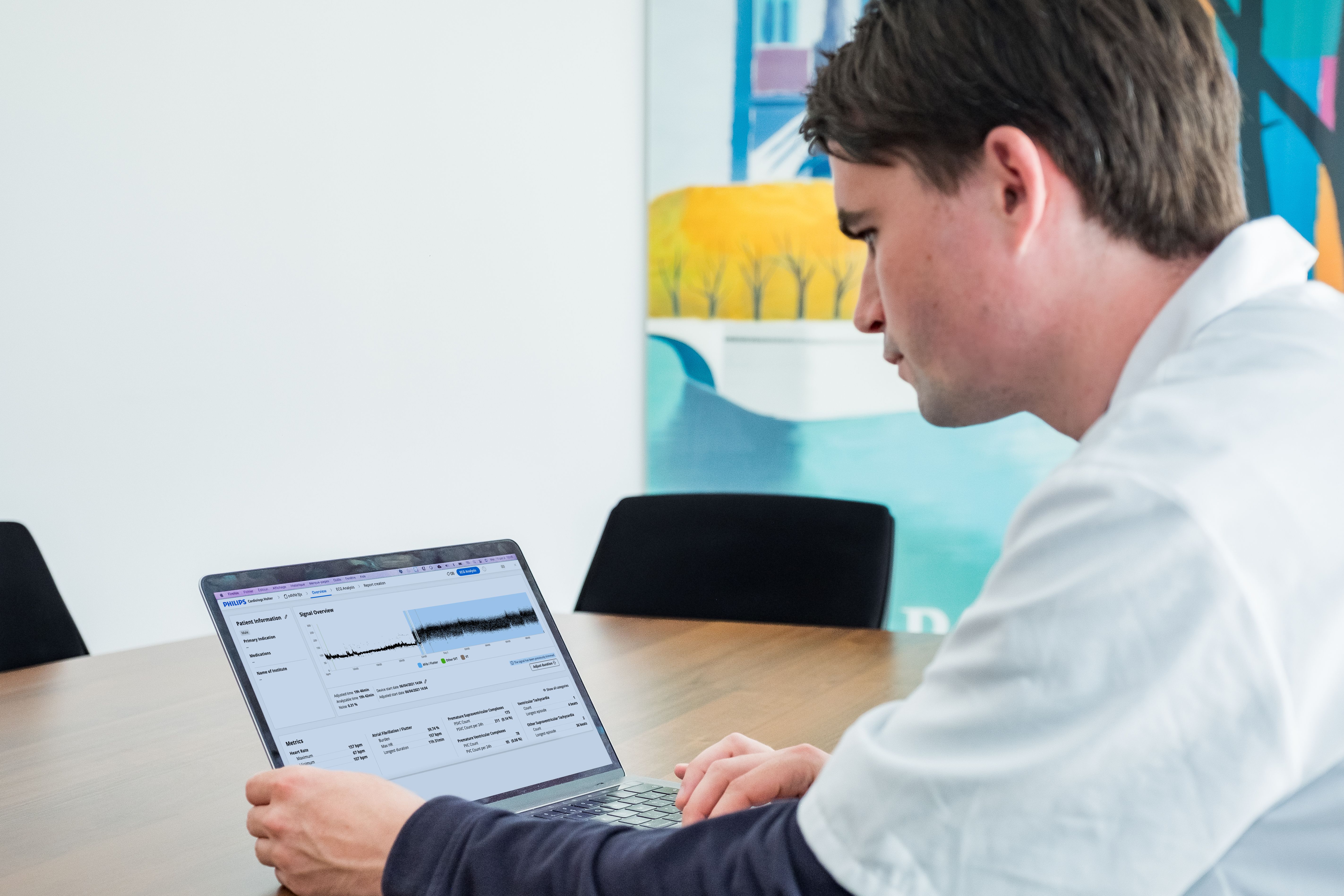 A clinician reviews Cardiologs Holter data on a laptop between consults
