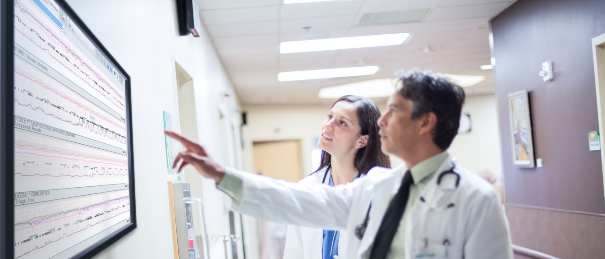 Two clinicians review ECG data to determine the next step in care.