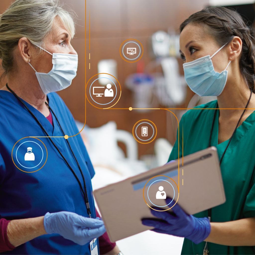 A clinician confers with a tablet 