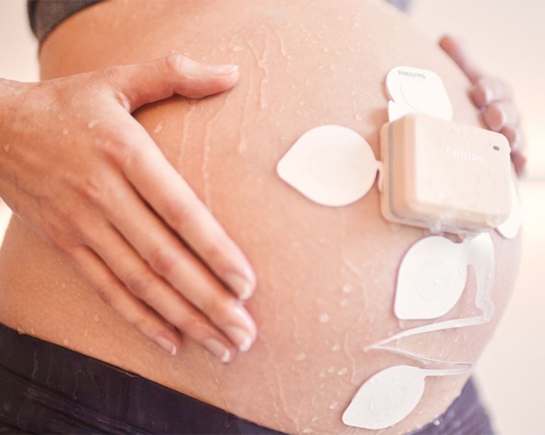 Image of a pregnant woman being monitored through a medical device.