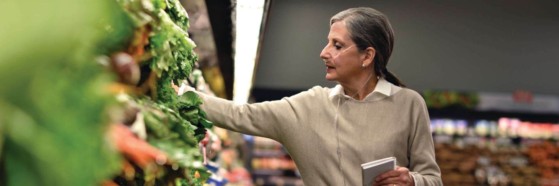 Image of a person shopping for groceries while wearing a portable medical device.