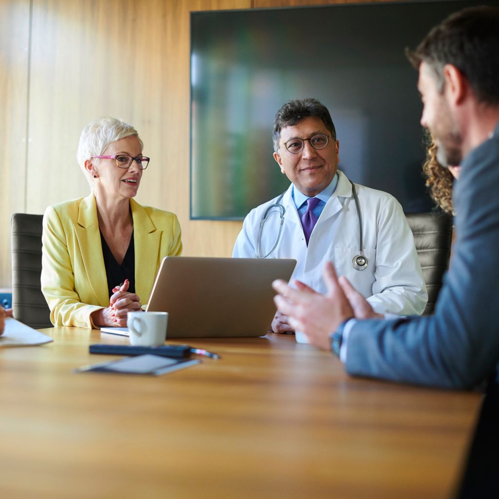 Stakholders collaborate during a hospital meeting.
