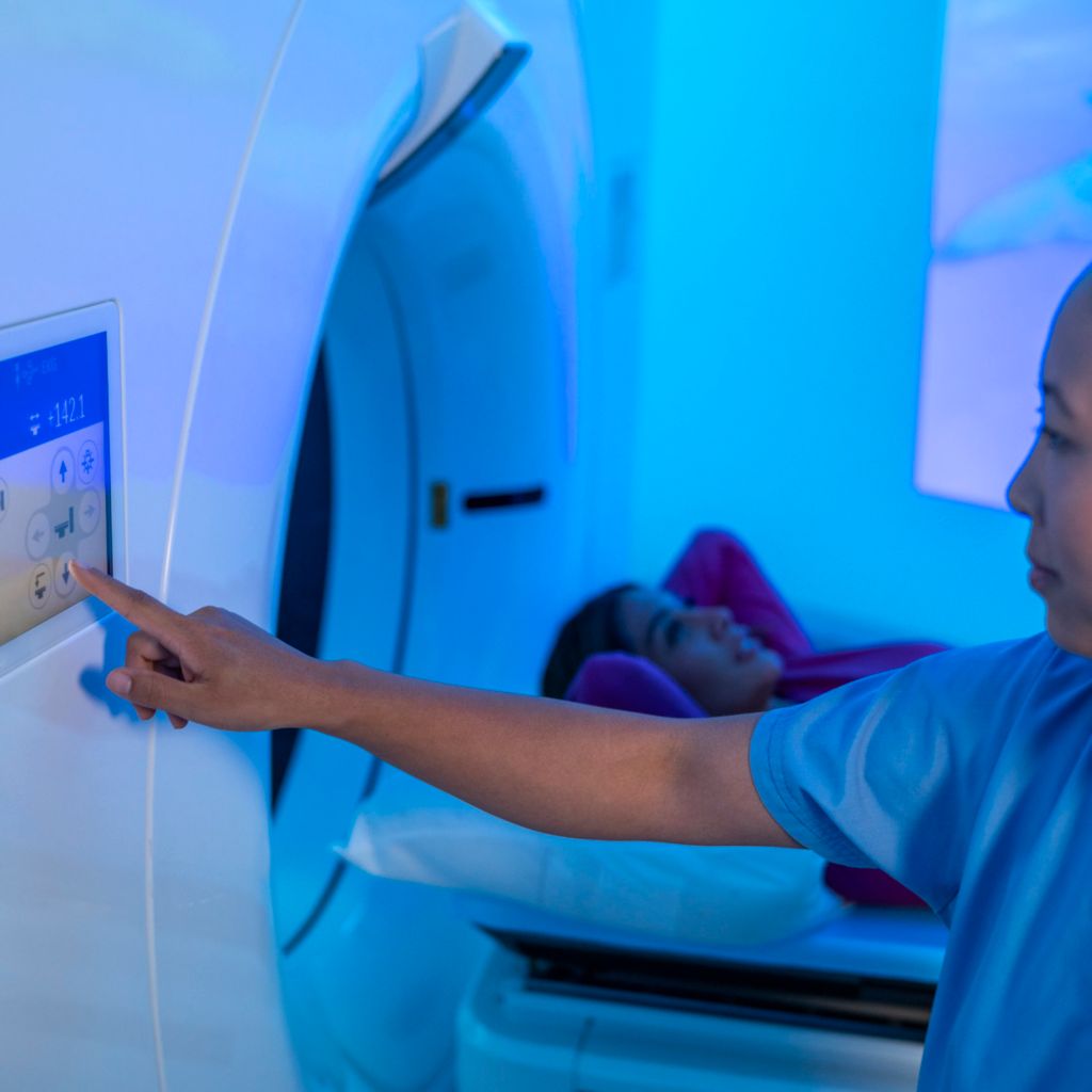 Healthcare professional using CT device