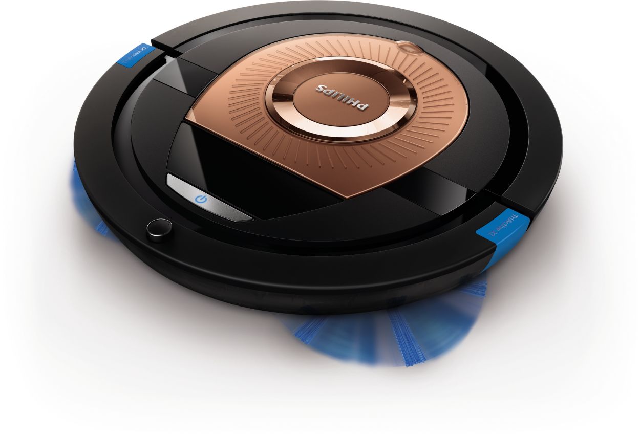  A black and copper robot vacuum cleaner with blue spinning brushes.