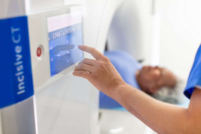 Philips Incisive CT in use by tech operator