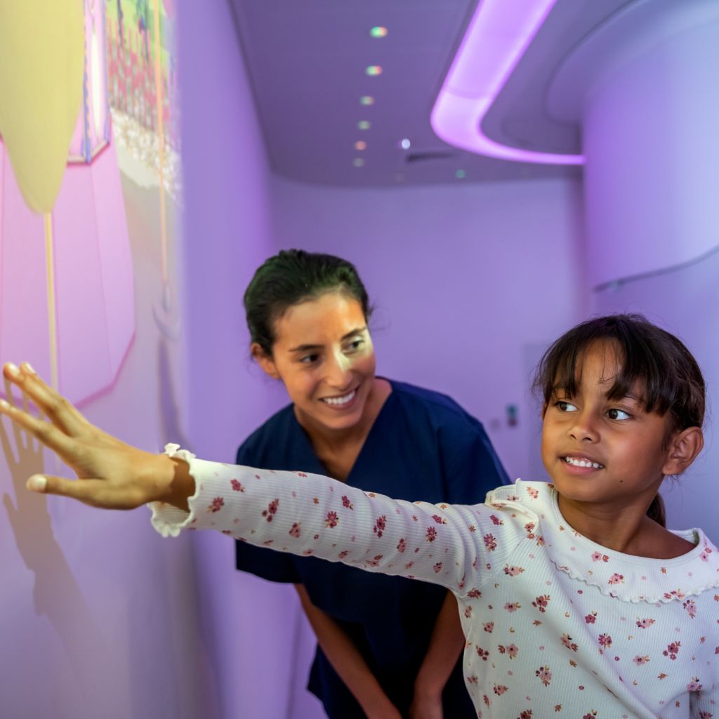  Pediatric Coaching - Girl playing with Ollie in Space theme prior to MRI exam and nurse watching - Ambient Experience