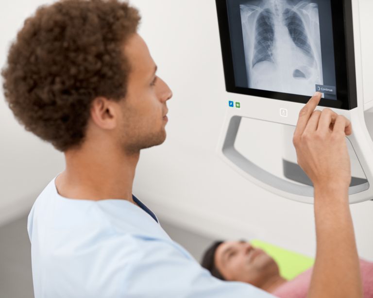 Technician performing chest x-ray