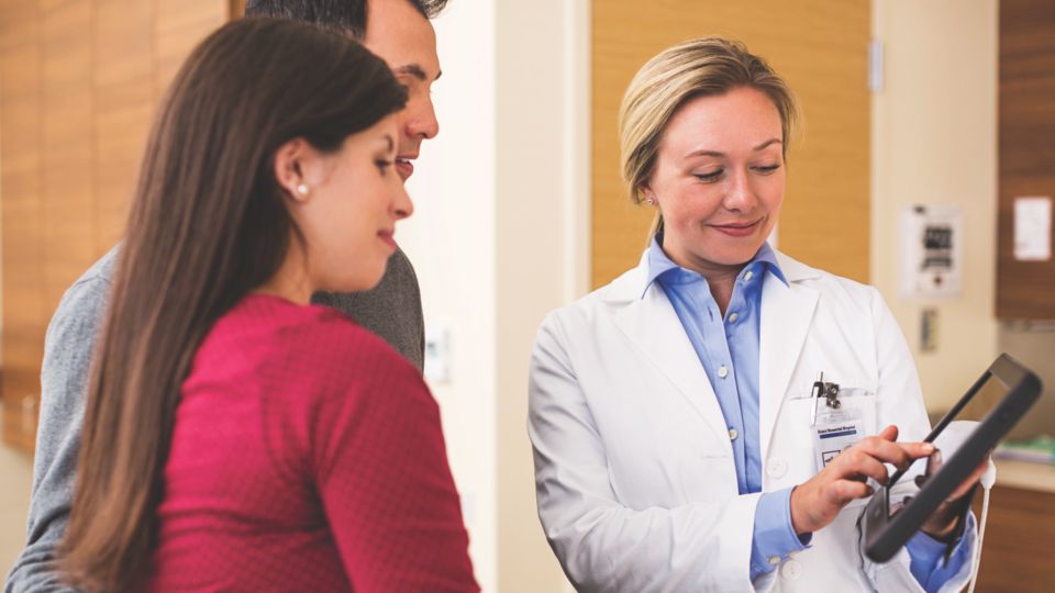 Doctor showing a digital image to patients