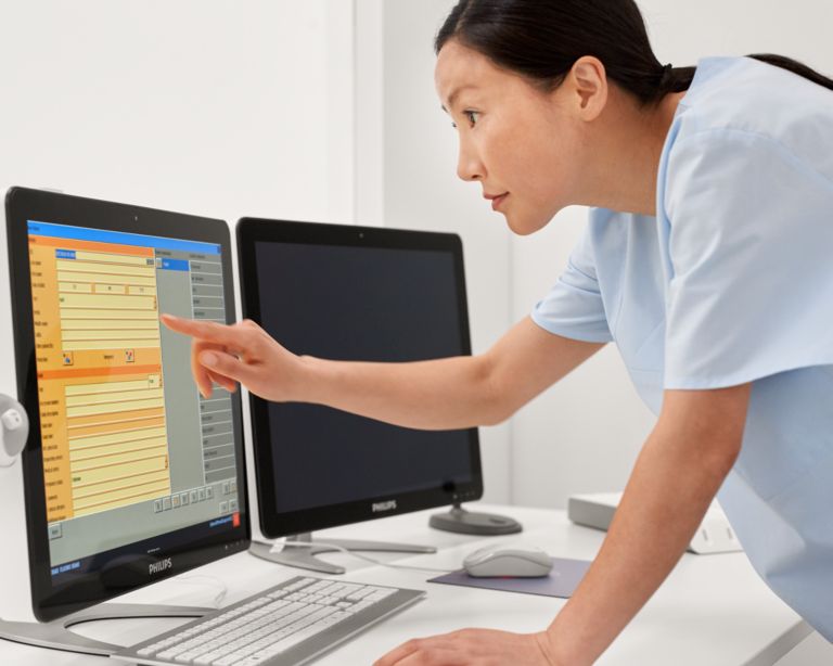 Technician standing using Eleva in fluoroscopy control room
