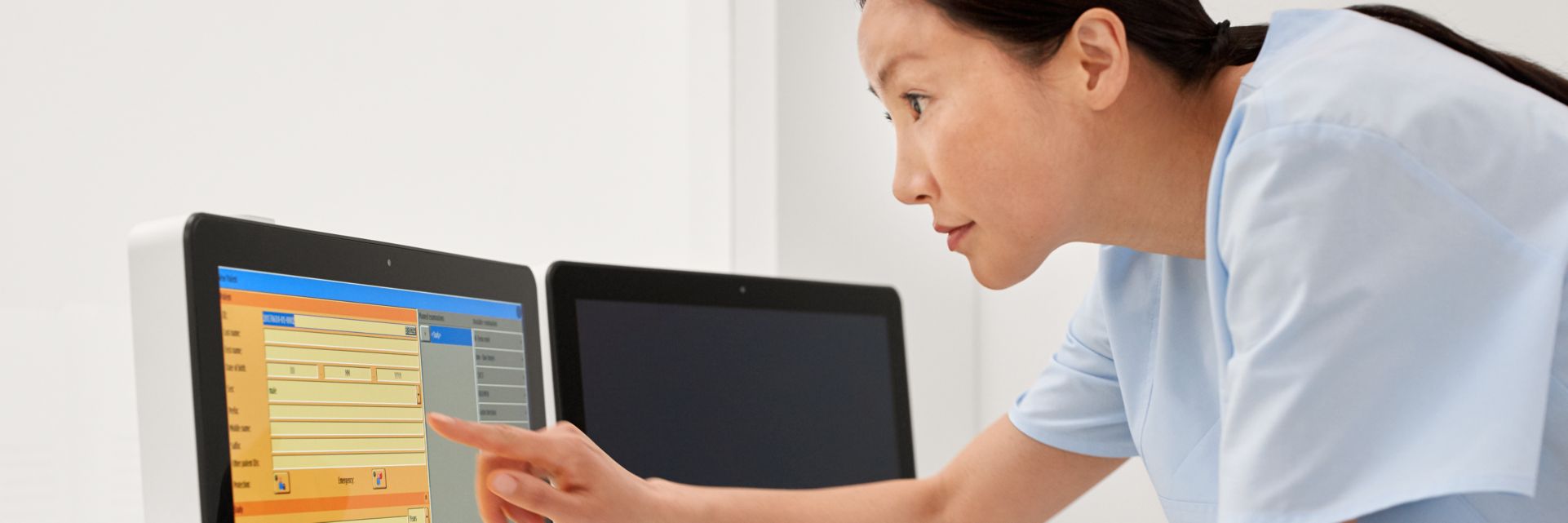 Technician standing using Eleva in fluoroscopy control room