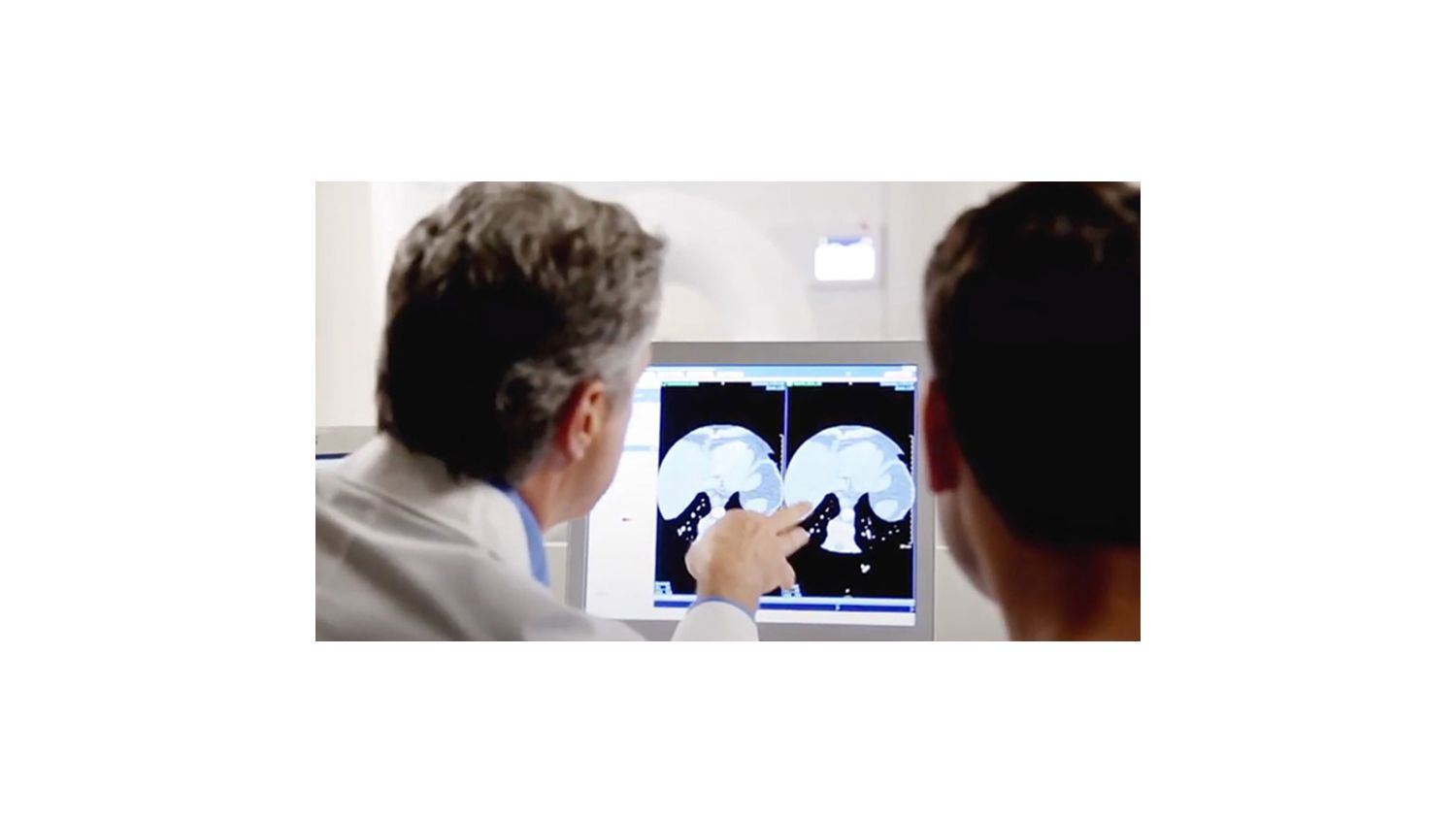 Two clinicians reviewing a scan.