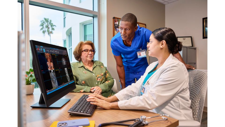 Doctors with patient reviewing a case