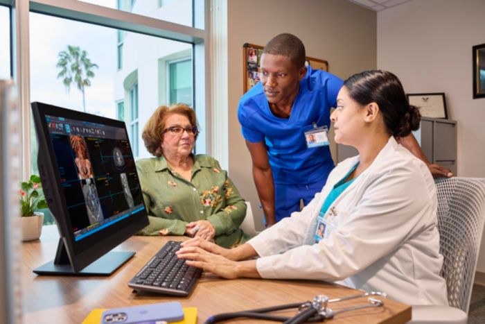 Doctors with patient reviewing a case