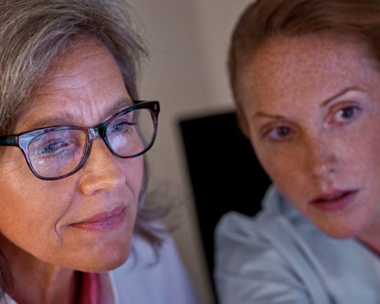  two healthcare professionals looking at a screen