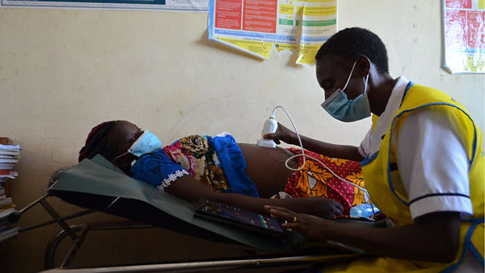 Health worker scans pregnant women in Kenyan primary health care facility