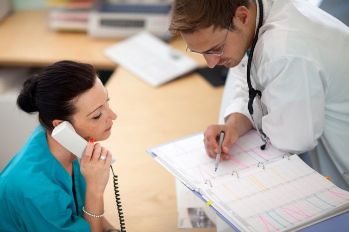 Two clinicians reviewing patient materials