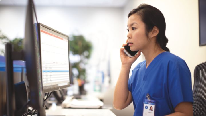 Nurse in phone at PIC iX central station