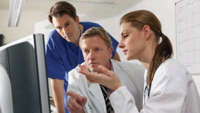 Medical team discussing patient data on screen