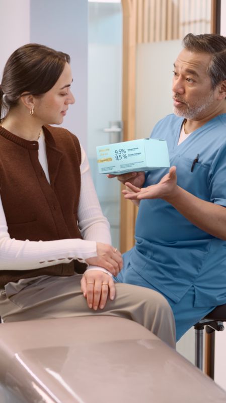 Woman placing a Phlips Zoom! take-home whitening tray