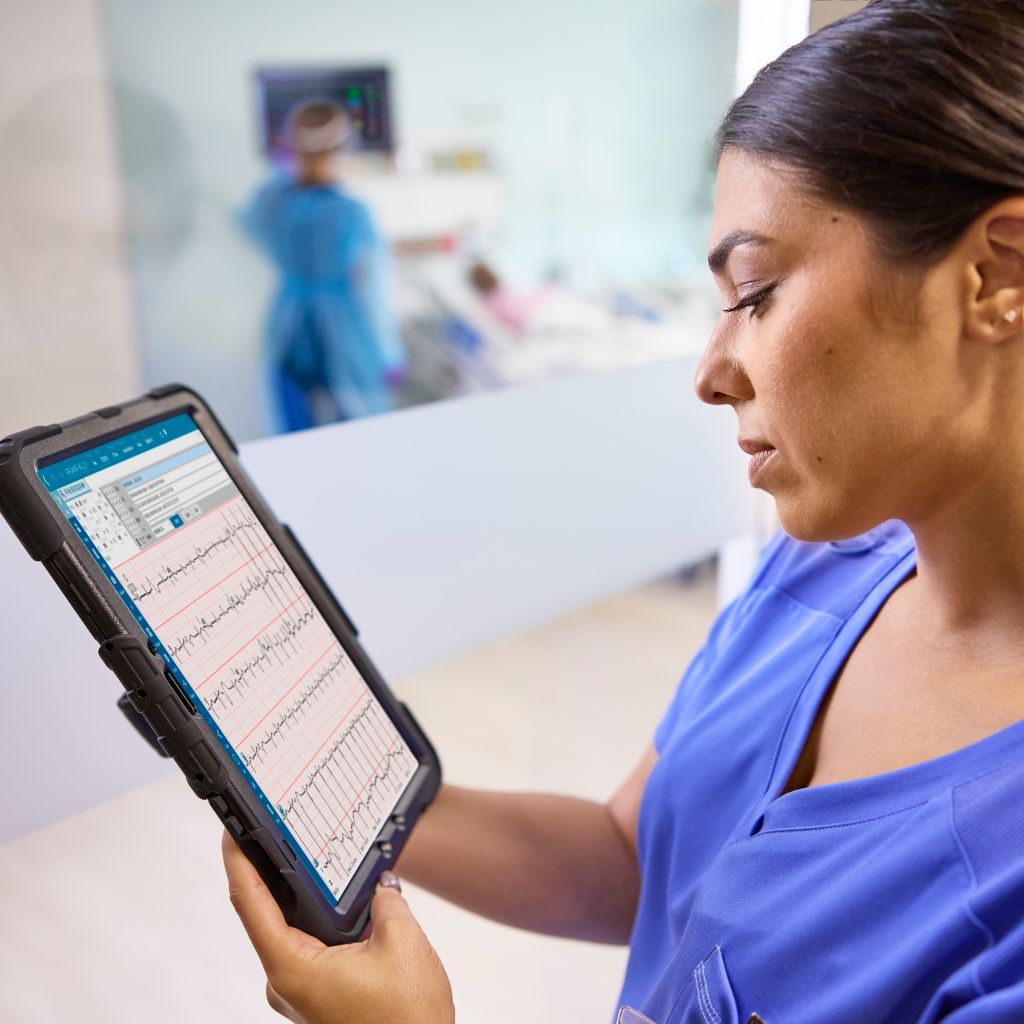 A clinician reviews ECG data on a tablet device while on the go.