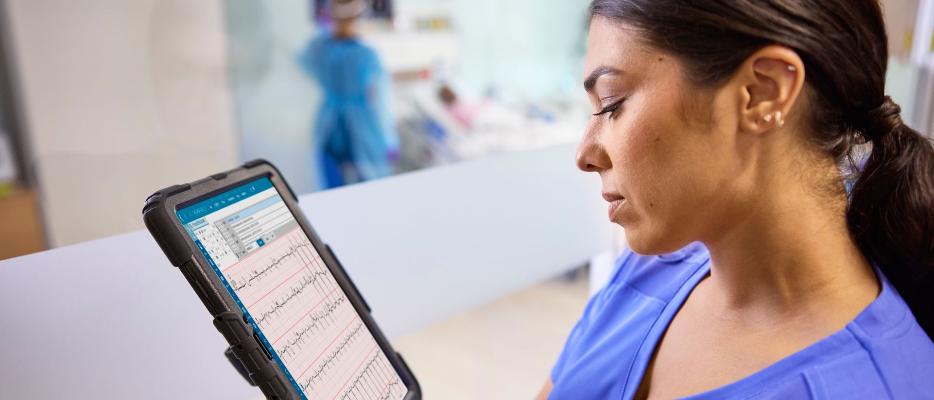 A nurse looks at iPad featuring the Philips ECG Al Marketplace