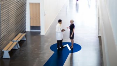 Doctor Discussing with Patient in Hallway