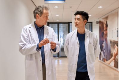 Two male doctors talking in hospital corridor