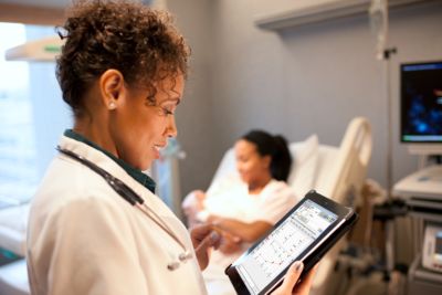 Female physician looking at medical record on tablet