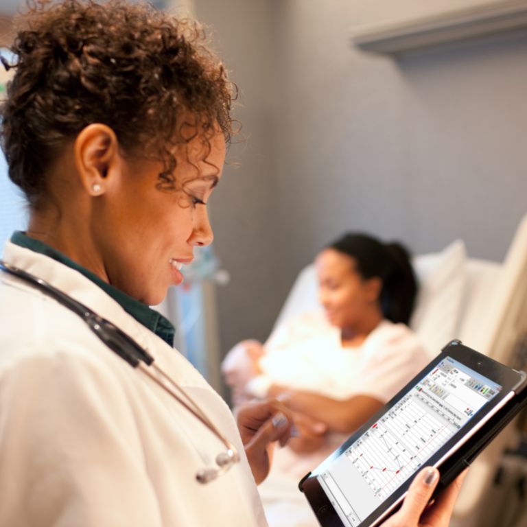 Female physician looking at medical record on tablet