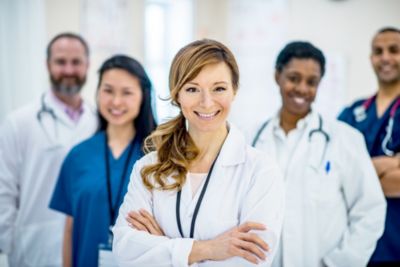 Female doctor standing in front of a team of healthcare professionals