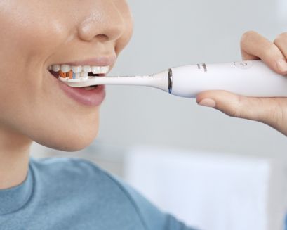 Patient brushing back teeth.