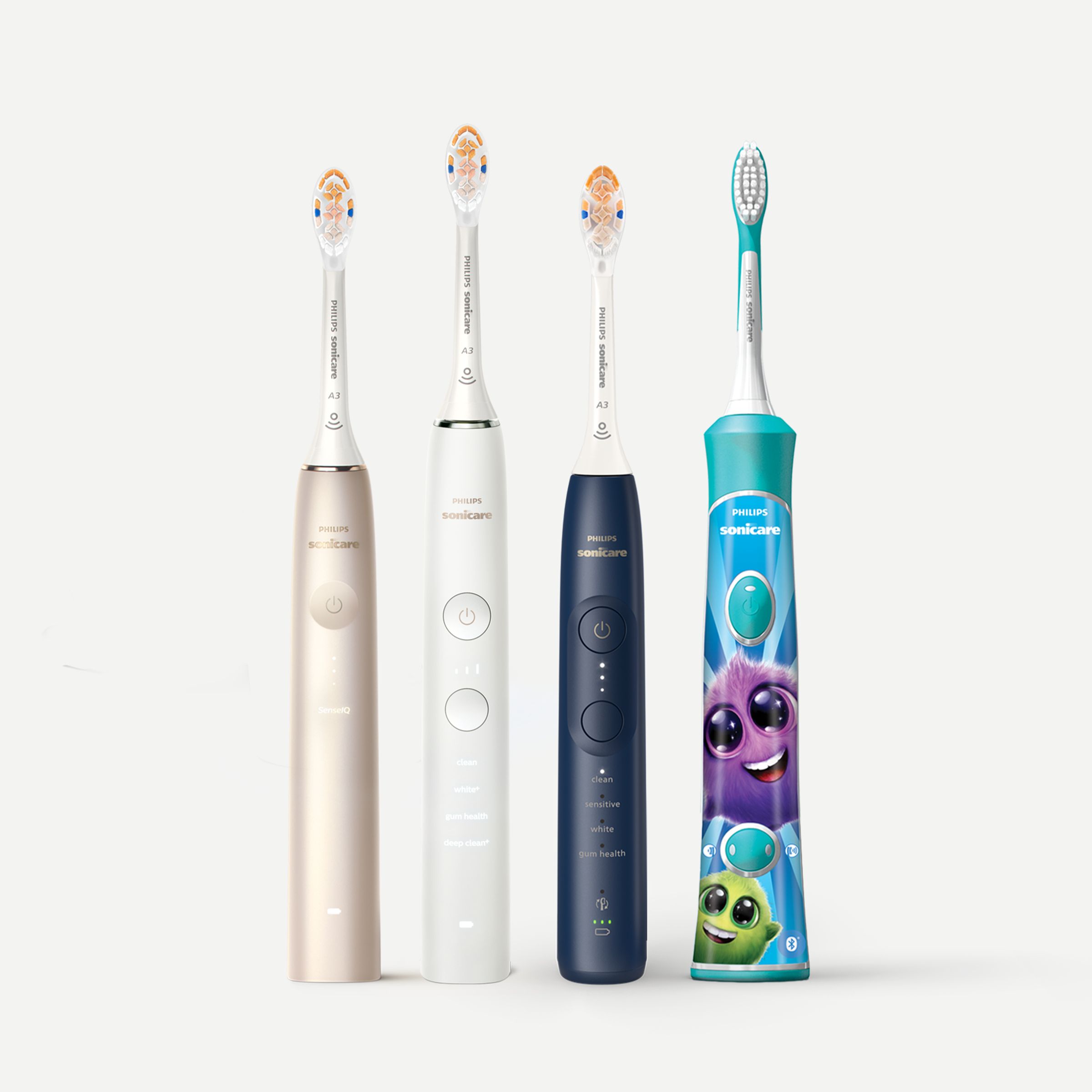 Sonicare power toothbrushes aligned on a countertop