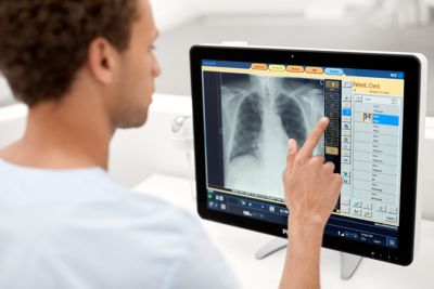 Radiographer in front of Eleva workstation of radiography system
