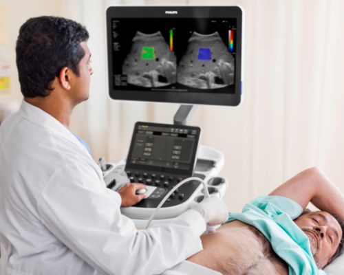 A clinician performs an abdominal ultrasound exam on a patient. 