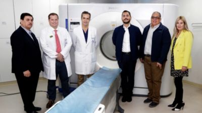 Radiologists and healthcare professionals standing beside Philips spectral CT scanner during training session