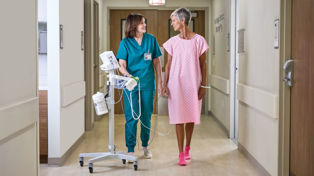 Clinician and patient with PM 6000 on roll-stand