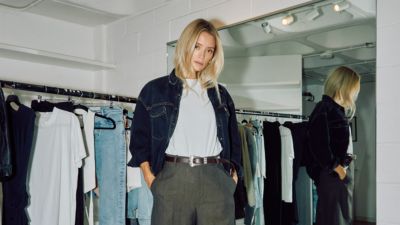 Styled outfit with white T-shirt and dark trousers in fashion studio