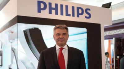 Prof. Dariusz Dudek at a healthcare conference in front of a Philips booth