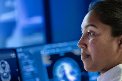 Clinician reviewing brain scan on Philips diagnostic imaging workstation