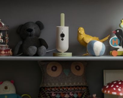Baby monitor on the shelf between toys