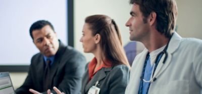 Healthcare professionals in meeting discussing patient care and clinical information