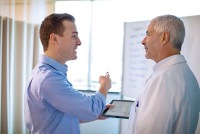 Professional and doctor interacting with Ipad