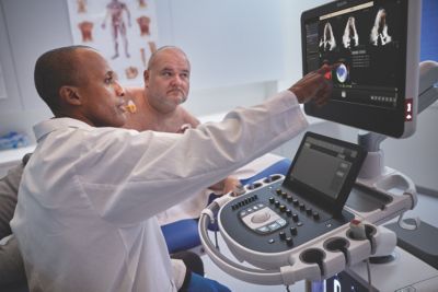 Clinician pointing to EPIQ Elite monitor showing patient cardiac scan results