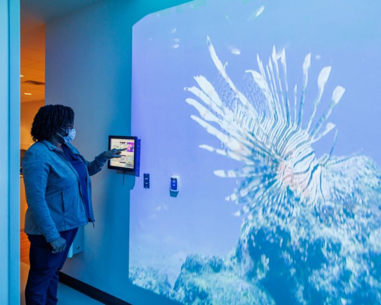 Nurse selecting Ambient Experience Theme for X-Ray Room at Children’s of Alabama