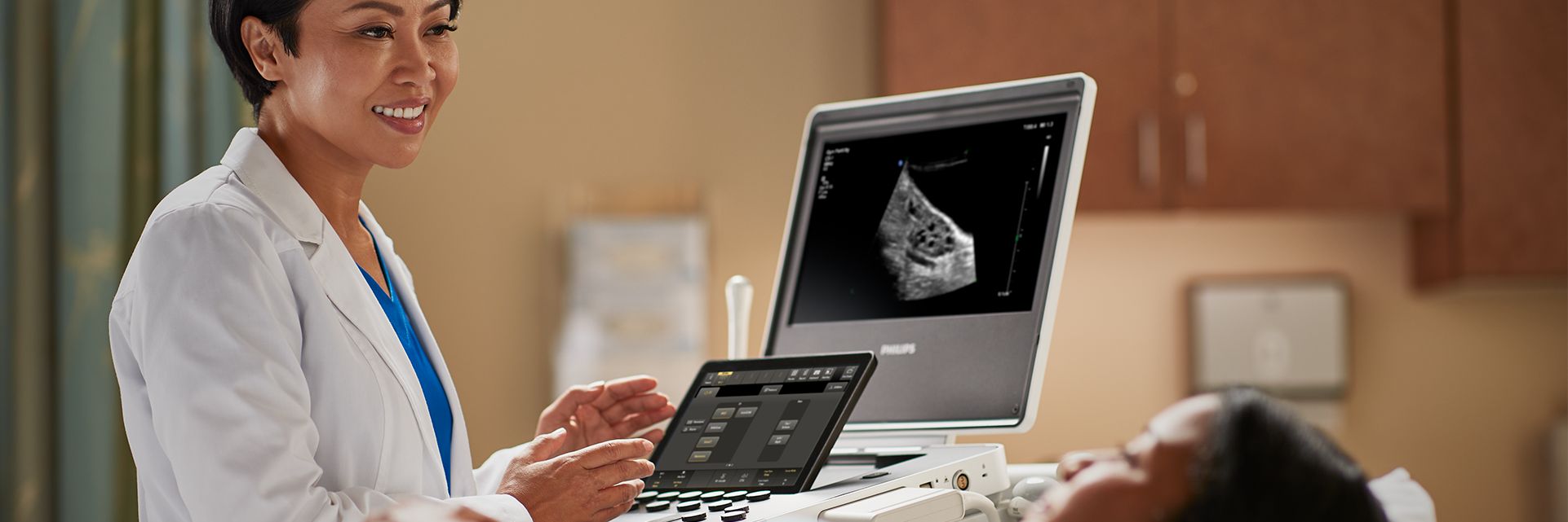 Doctor using Compact Ultrasound System 5000 series Ob/Gyn to conduct patient exam