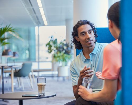 Philips employees indoors office talking