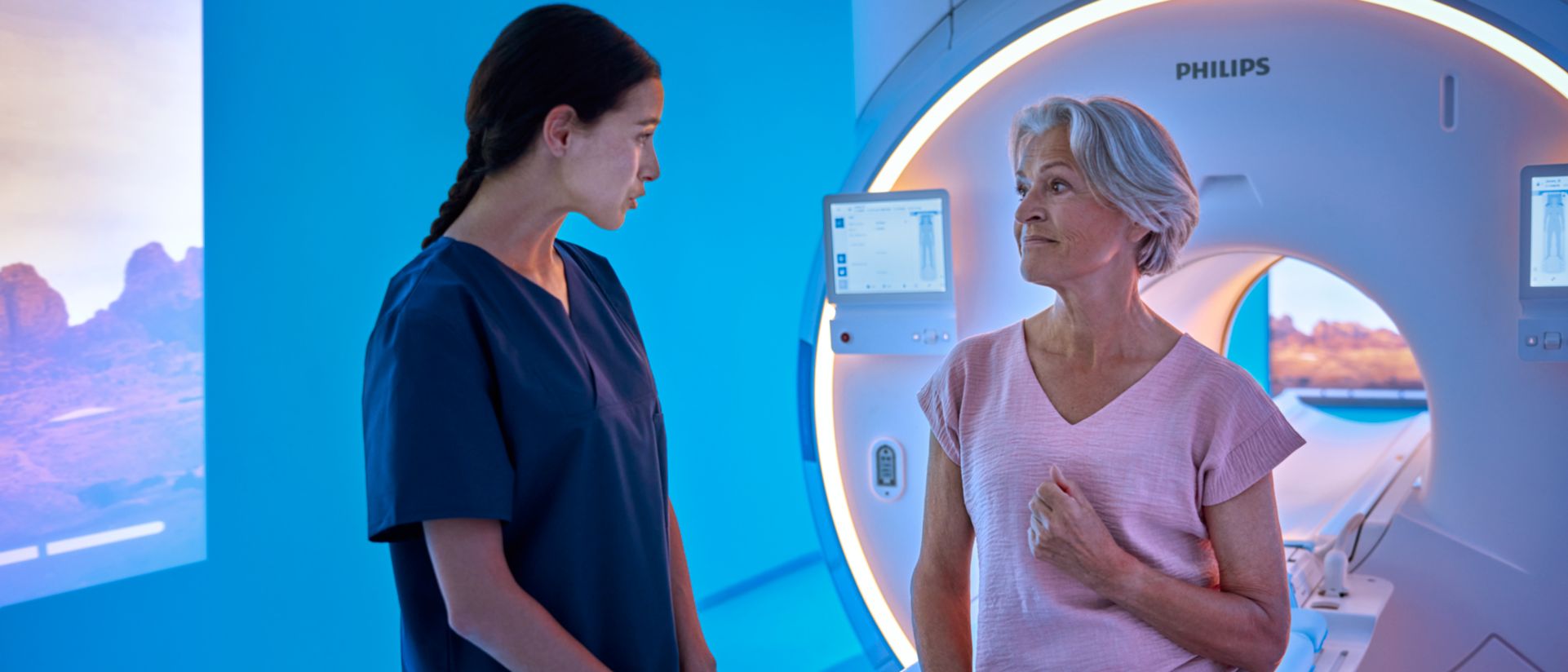 Elderly woman speaking to nurse before MR