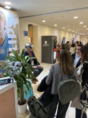 Attendees observing virtual ICU experience at nursing management conference